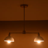 Modern brass pendant light with soft symmetrical glow from two domes