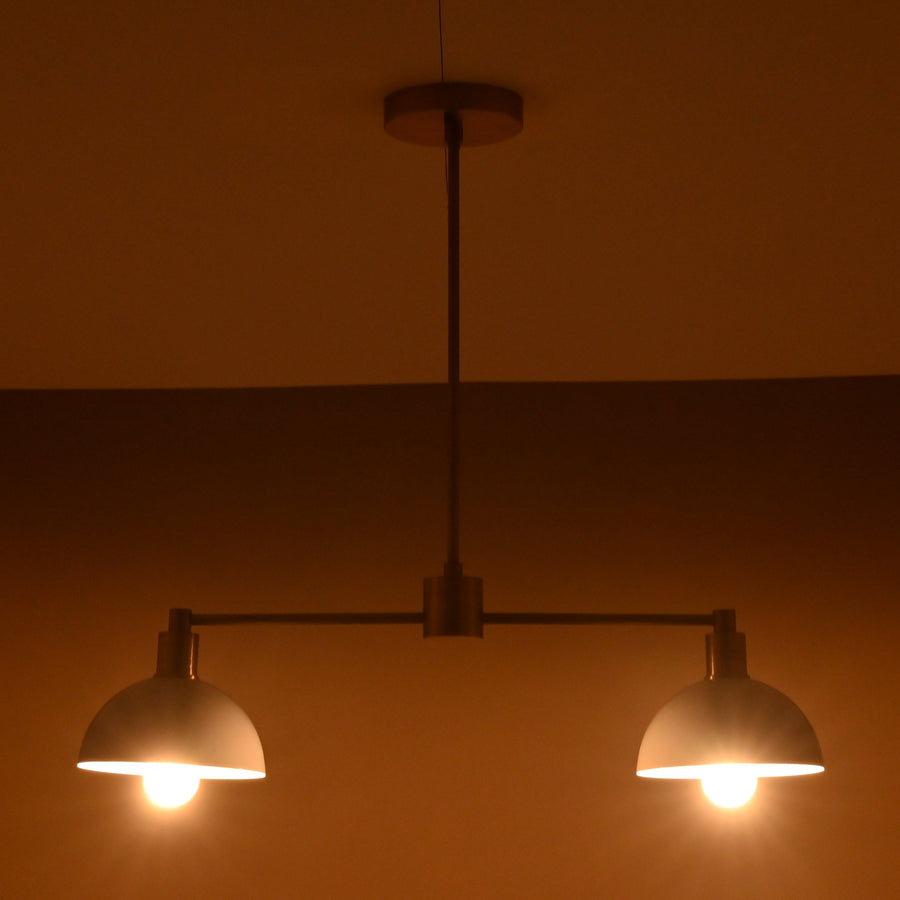 Modern two-light brass pendant with white domed shades and sleek minimalist design