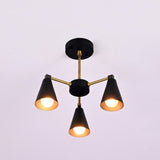 Front view of minimalist cone style brass chandelier with three lights and matte black accents