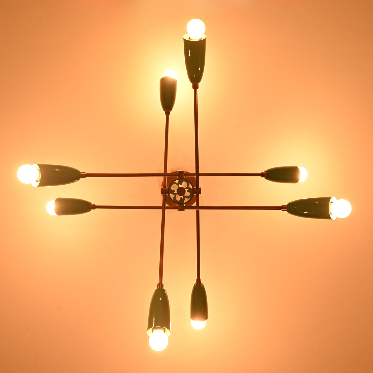 Underside detail of mint green brass sputnik chandelier showcasing handcrafted structure and warm light.
