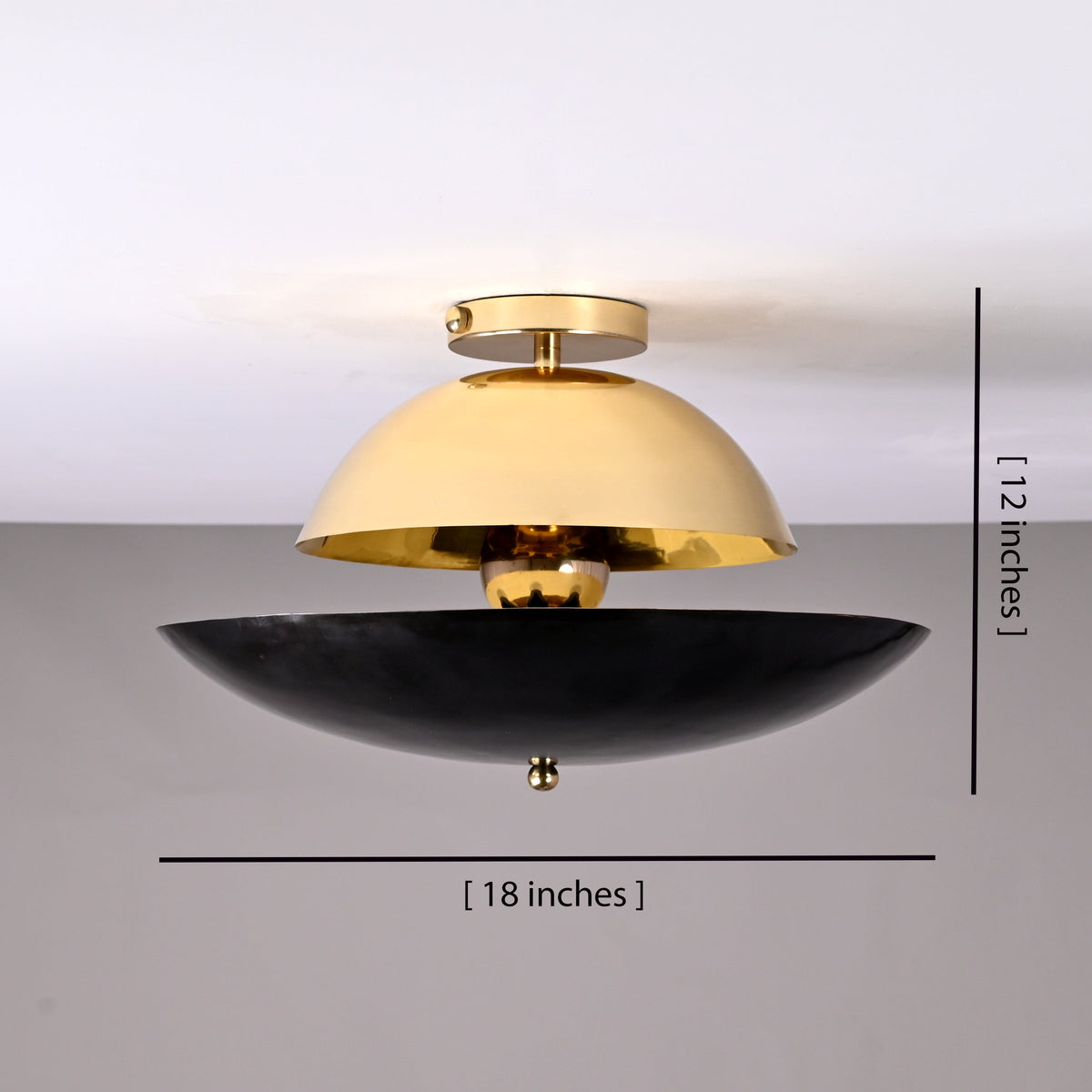 18-inch mixed-finish brass flushmount light shown with 12-inch height measurement, featuring polished brass top shade and blackened lower bowl.