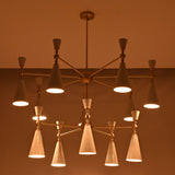 Modern 12-light cone chandelier shown on white background with brushed brass structure and white enamel painted shades