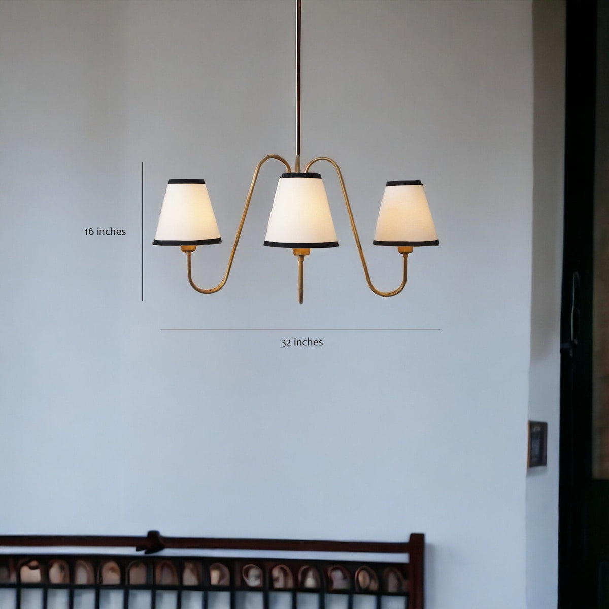 Modern brass chandelier with three lights and labeled dimensions – 32 inches width, 16 inches height