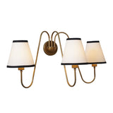 Modern 3-light brass wall sconce with elegant curves and white shades viewed from the side