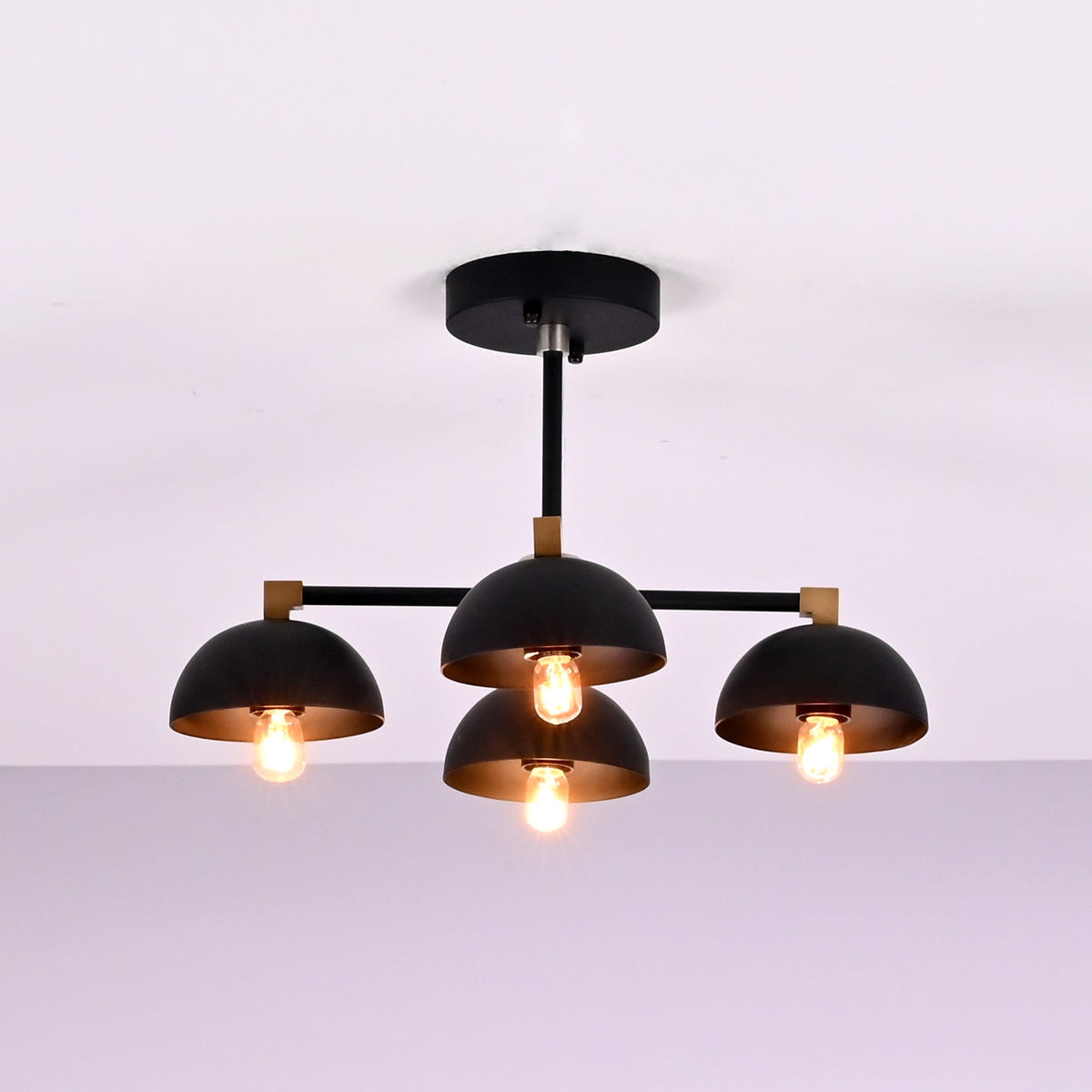 Modern 4 light brass bowl flush mount ceiling light with matte black finish and warm ambient glow by Brass Leaf Studio.