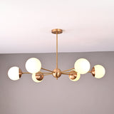 Handmade 6-globe brass chandelier featuring opal glass globes and brushed brass finish for modern interiors.