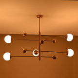 Modern bedroom globe ceiling light with five lights arranged on a clean architectural brass frame