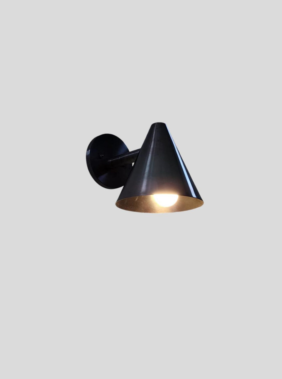Modern blackened brass cone wall light handcrafted by Brass Leaf Studio, featuring minimalist cone design and matte antique finish.
