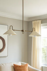Modern 2-light brass cone chandelier providing soft ambient light in a neutral living room interior