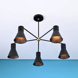 Angled view of 5 cone brass chandelier showing warm glow and tapered cone metal shades