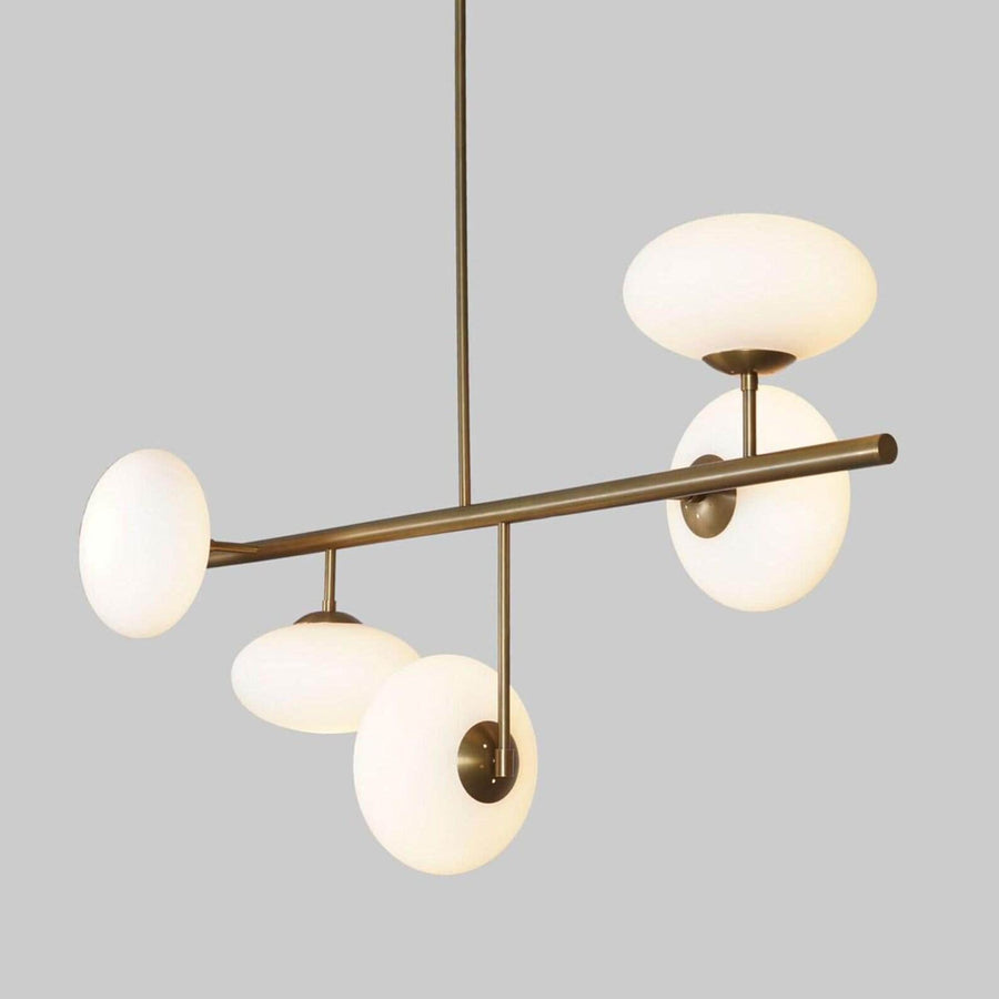 Front view of a modern brass globe chandelier with five lights, designed for dining rooms and living spaces with warm ambient illumination.