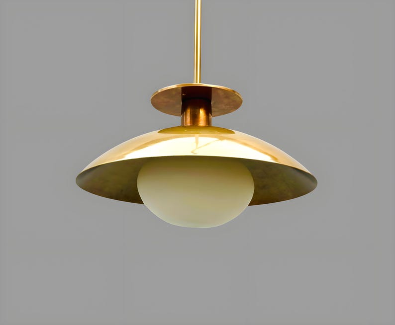 Modern brass bowl pendant light with glass globe diffuser, minimalist industrial ceiling fixture in brushed brass