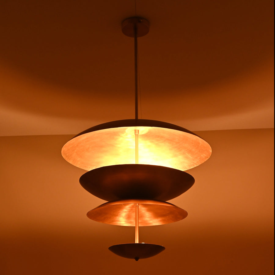 Front view of modern layered brass 6-light disc chandelier with sculptural floating bowl shades.