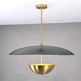 Front view of modern brass dual-shade pendant featuring a wide dome and inner brass bowl in a sculptural contemporary design.