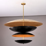 Modern sculptural brass chandelier featuring stacked black and gold discs crafted in a unique layered floating design.