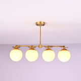 Modern linear brass chandelier with four opal glass globes, designed for dining rooms and contemporary interiors.