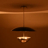 Modern chrome brass chandelier showcasing warm lighting effect with reflective polished surfaces