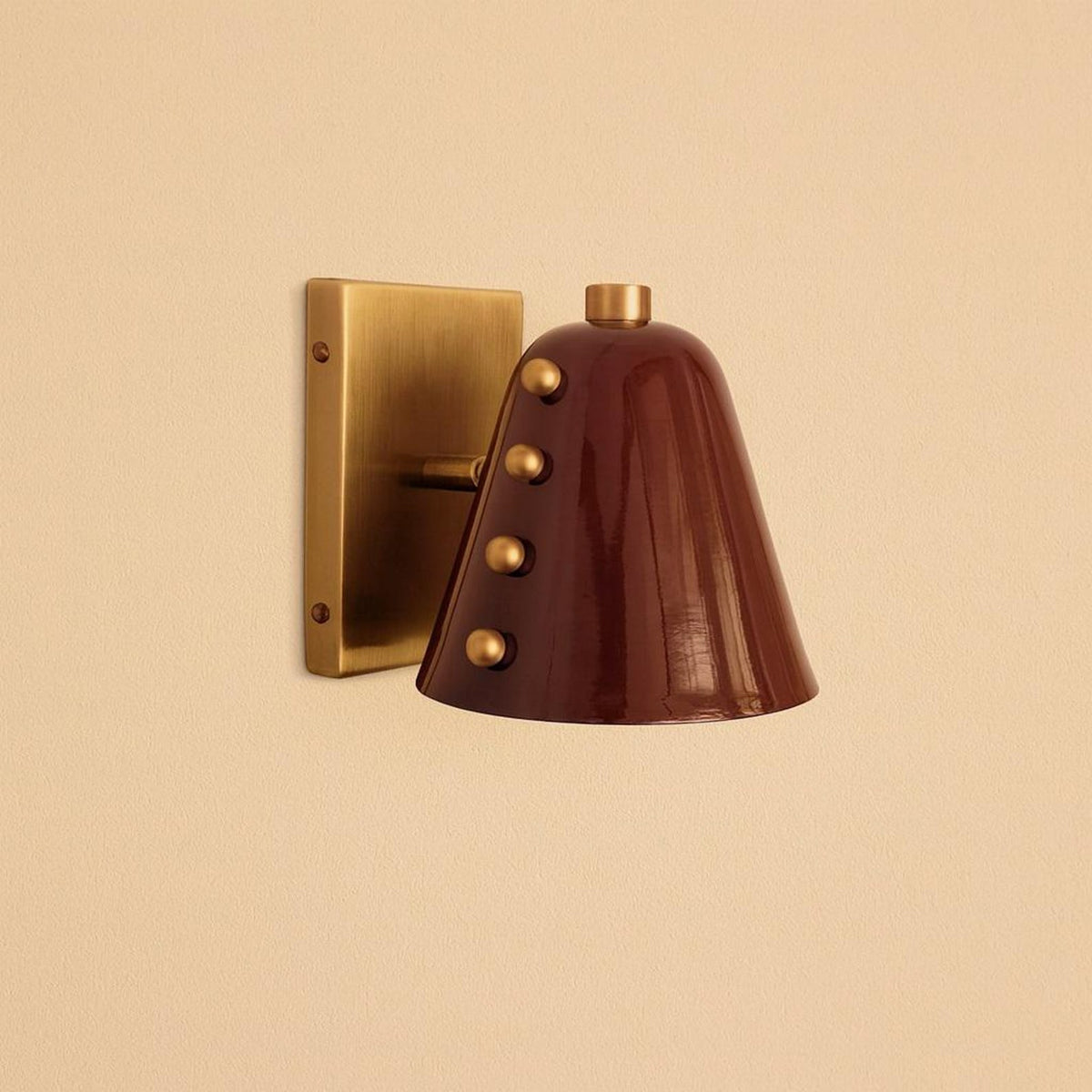 Modern industrial brass wall lamp with burgundy cone shade and decorative brass accents