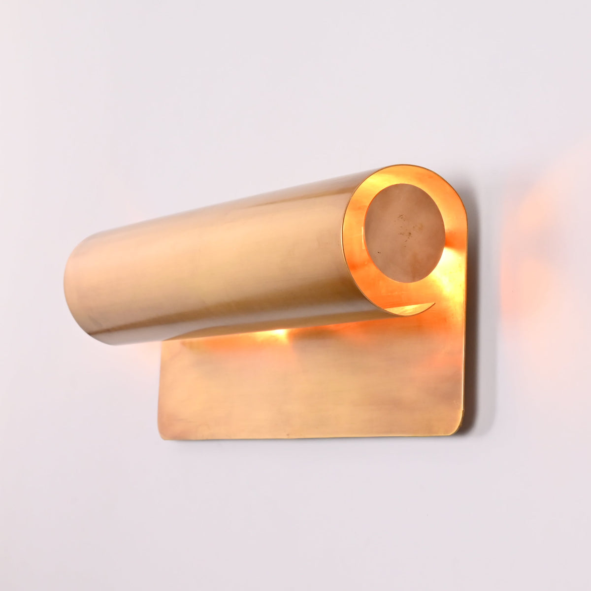 Brass wall sconce styled in office and library interior with soft architectural wall lighting