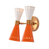 Orange and white diabolo wall light with perforated shade details and warm brass hardware