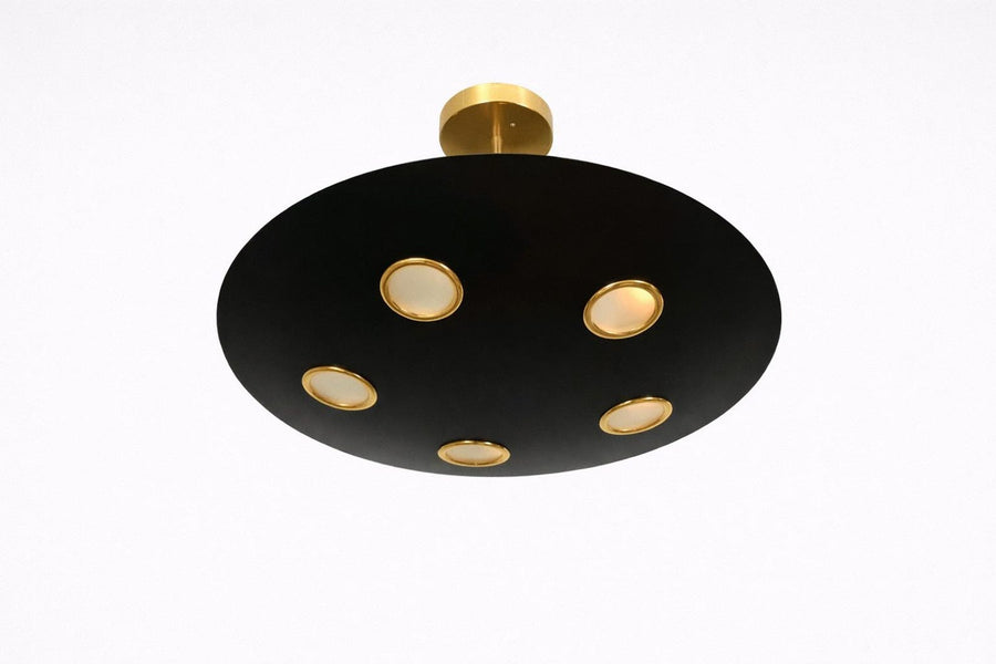 Orbit disc brass chandelier in matte black with gold accents, featuring five recessed lights for warm ambient ceiling illumination.