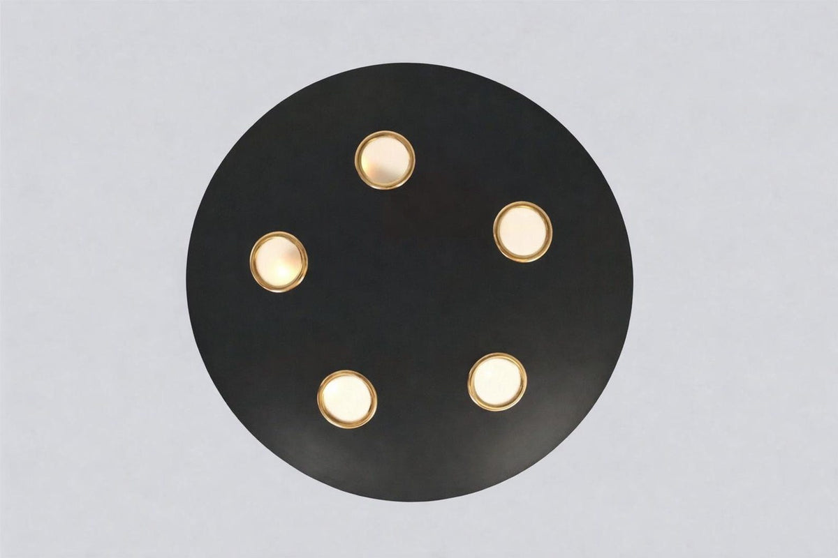 Bottom view of orbit disc chandelier highlighting circular black brass plate and five brass-trimmed light openings.