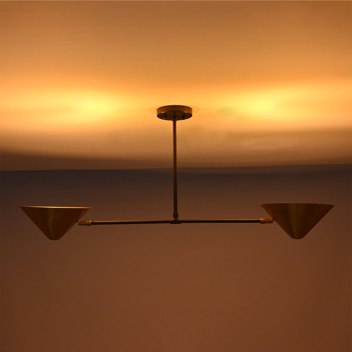 Oslo Modern Double Cone Linear Chandelier creating warm indirect ceiling illumination