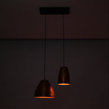 Oslo Modern Dual Copper Pendant Chandelier glowing with warm ambient light in a dark setting