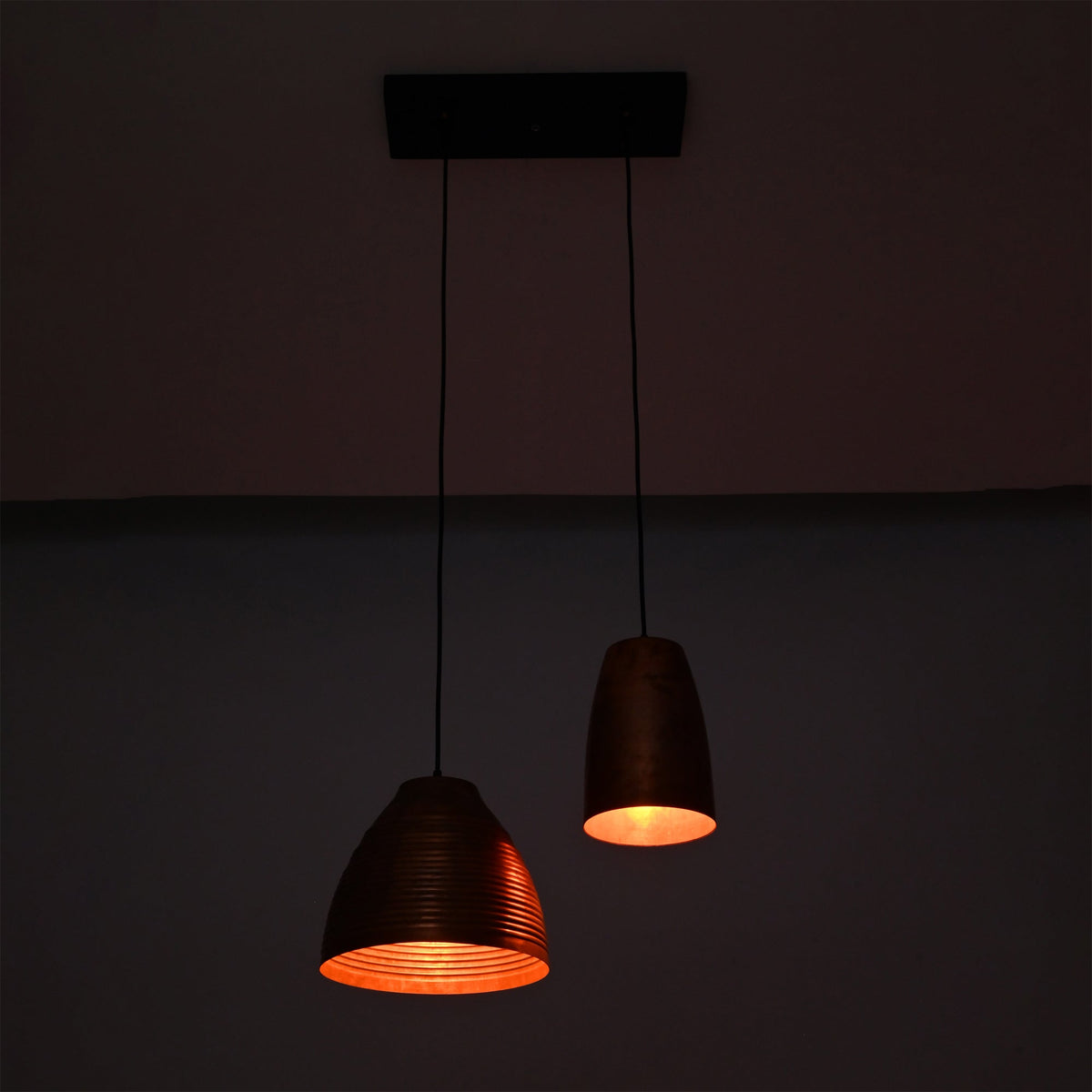 Warm illuminated Oslo Modern Dual Copper Pendant Chandelier highlighting handcrafted copper interiors