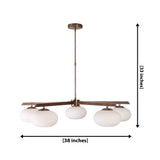 5-light oval glass ball chandelier shown illuminated with warm ambient glow and brass linear frame