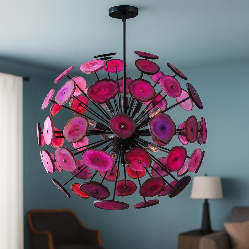 Pink agate stone chandelier with black metal frame creating dramatic contrast in a contemporary interior