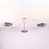Close detail of polished chrome brass bowl shades on a modern semi flush mount ceiling light.