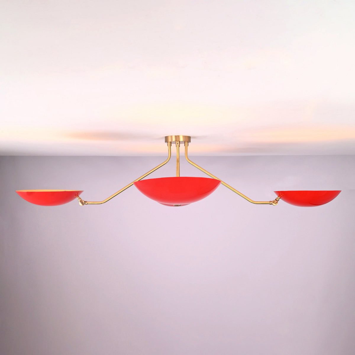 Front profile of red disc flush mount ceiling light with brushed brass structure and bowl shaped shades for indirect ambient lighting.