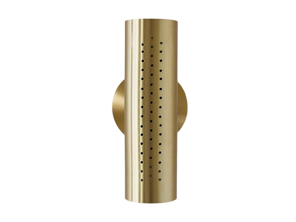 Close front view of perforated brass cylinder sconce showing perforation pattern and brushed brass finish on a white background.