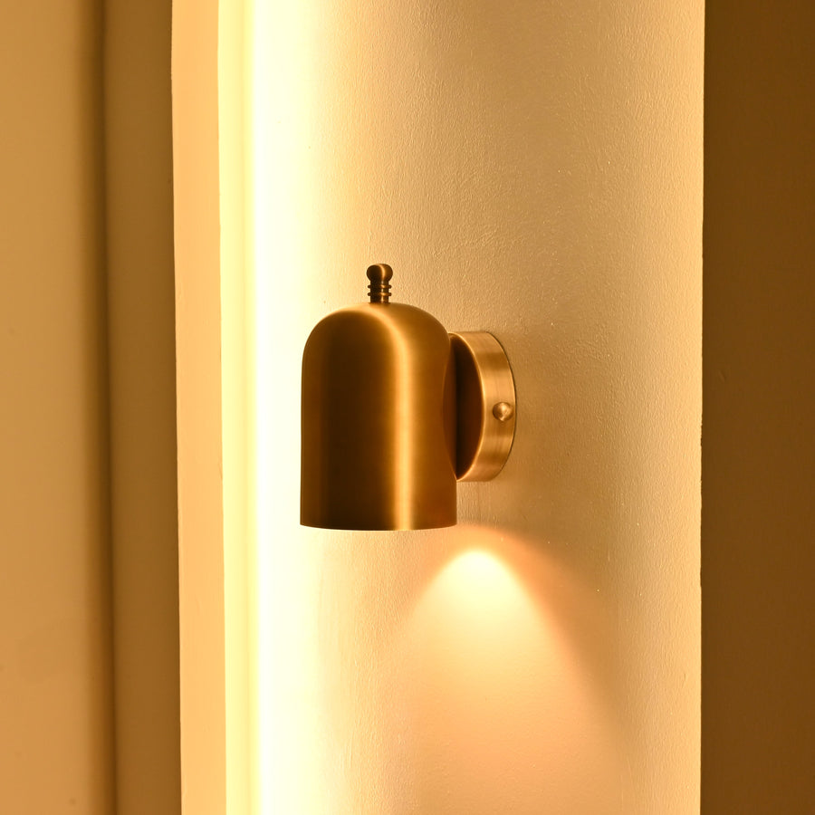 Cylindrical hallway wall light producing a soft downward pool of warm light for corridors and entryways
