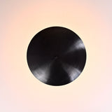 Top view of blackened brass bowl ceiling light showing circular uplight pattern