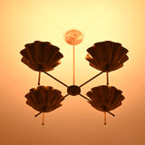Bottom view of brass bowl chandelier with warm ambient lighting and symmetrical shell shade layout