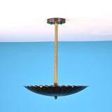 Side angle view of handcrafted scalloped brass pendant light with pleated disc shade