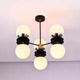 Close view of sculptural brass disc chandelier detailing opal glass globes and solid brass craftsmanship