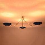 Sculptural brass flush mount ceiling light showcasing dramatic warm indirect lighting