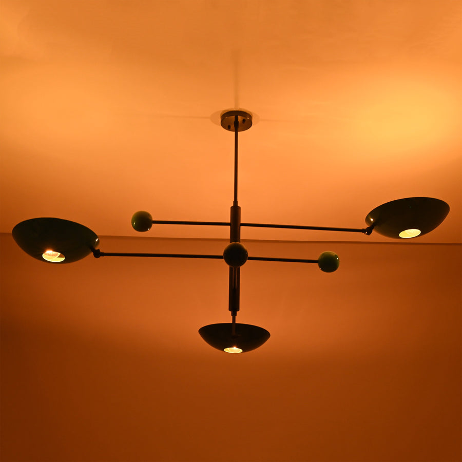 Handcrafted sculptural disc chandelier with multi-arm design and colored bowl shades in modern brass finish