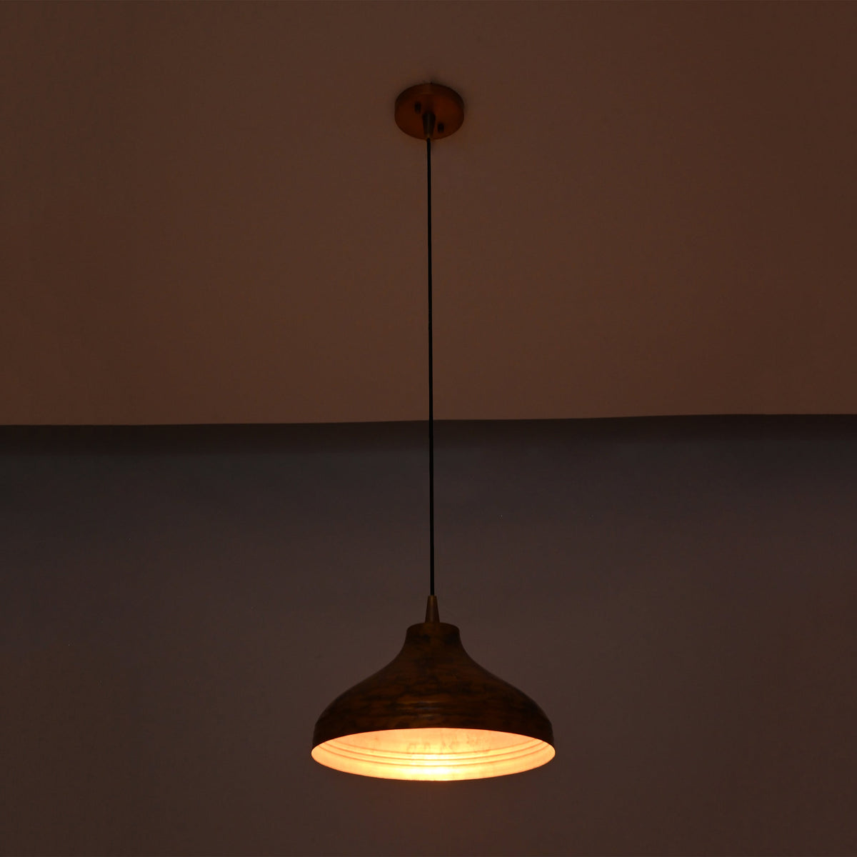 Single solid copper dome pendant with black cord and round copper canopy on a clean white background