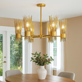Six light sculpted brass chandelier installed above a dining table, creating warm ambient lighting with modern industrial elegance.