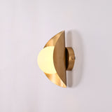 Solara crescent globe wall sconce shown in office interior with warm ambient wall glow