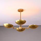 Top angled view of solid brass chandelier with four hammered bowl-shaped shades, highlighting craftsmanship and modern sculptural form.