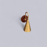Overhead view of solid brass and wood wall light showcasing the refined texture and craftsmanship of Brass Leaf Studio.