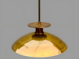 Top view detail of solid brass bowl pendant light showing handcrafted brass canopy and lacquered finish