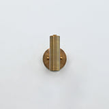 Solid brass cylinder wall light with focused downward glow, ideal for bedside reading and hallway lighting