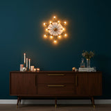 Solid brass Sputnik wall sconce shown from front with radial 12-arm design and round central wall canopy