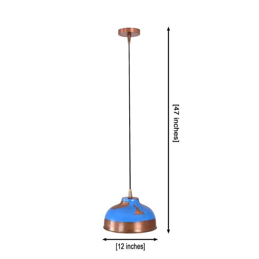 Blue patina solid copper dome pendant light hanging above a kitchen island with warm downward glow